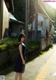 A woman standing in the middle of a street.